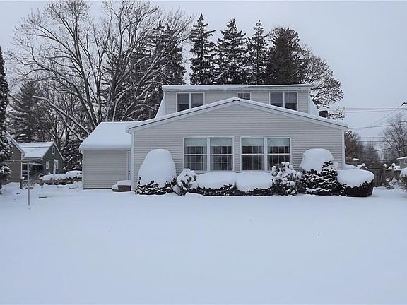 Large and level partially fenced rear yard with electric pet fence and garden shed.
