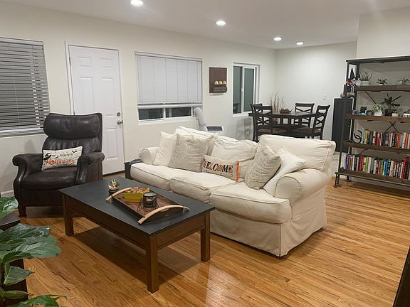 This is also showing the living room and dining room, as well as the door to the backyard and laundry/storage.