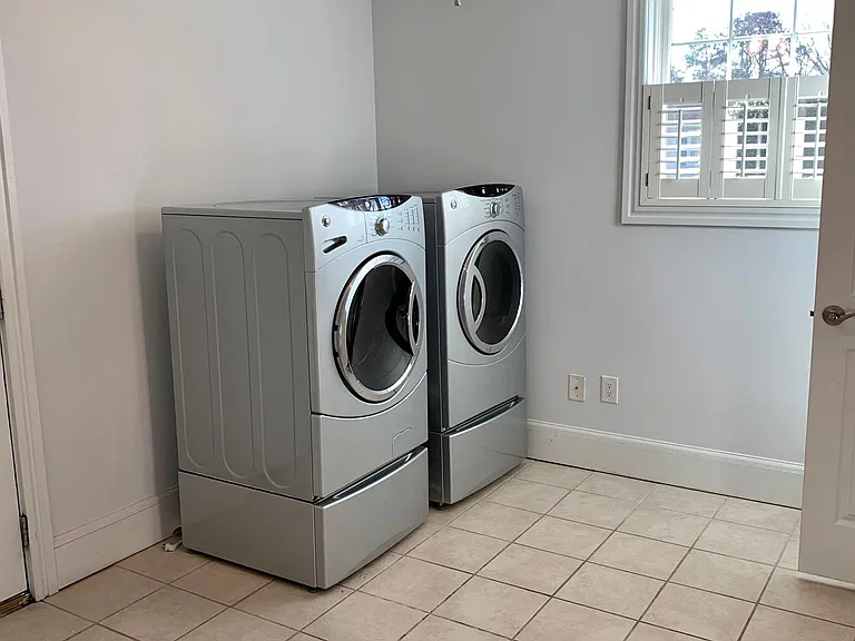 Spacious laundry room complete with front load washer and dryer. Located on same floor as master bedroom and bath.