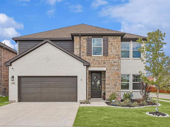 View of front of house featuring a front yard and a garage