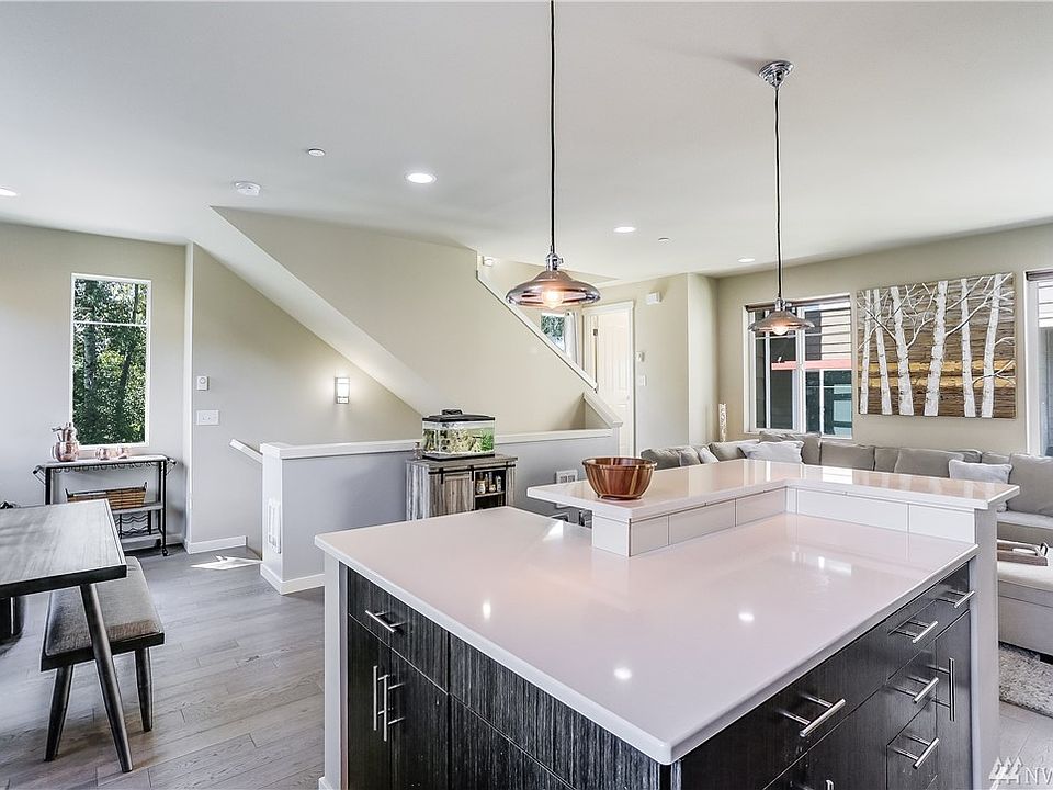 Open concept living here! The kitchen, dining and living rooms flow easily together. Notice the gorgeous engineered hardwood floors. 
