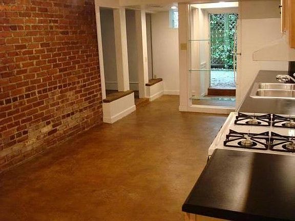 Exposed brick runs the length of the kitchen wall.