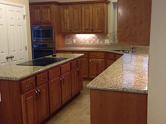 Kitchen has cooktop, large pantry and beautiful knobs and handles on the cabinets.