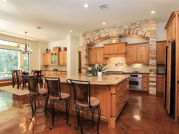 Kitchen (from Family Room) Stone surround! Tons of cabinets! Huge island that is great for entertaining!