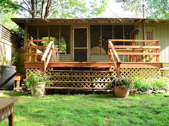 The large screen in porch has a fan, plenty of room for a hammock (included), lots of seating, and even a dining table.