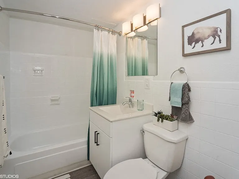 Bright bathroom with tub and vanity storage
