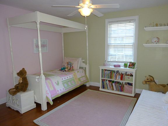 One of two secondary bedrooms with reachin closet, hardwood floors, a sunny window and ceiling fan.
