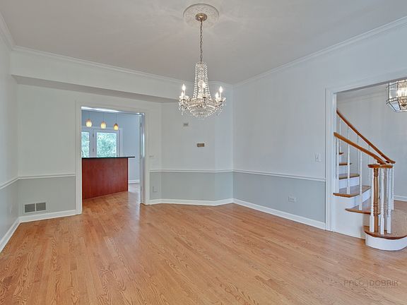 A crystal chandelier adds sparkle to the dining room