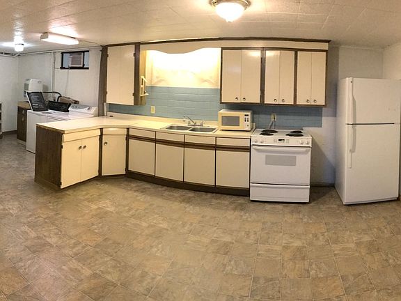 Kitchen looking from living room. Stairs to entrance on the left. Laundry room to left of kitchen.