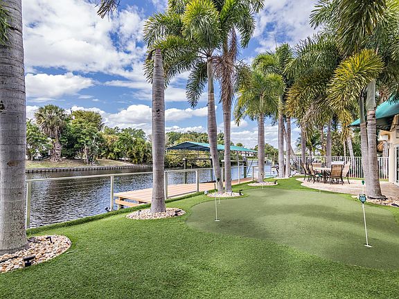 Backyard three hole putting green, with patio, outdoor grill, hot tub, boatlift, deck and dock!