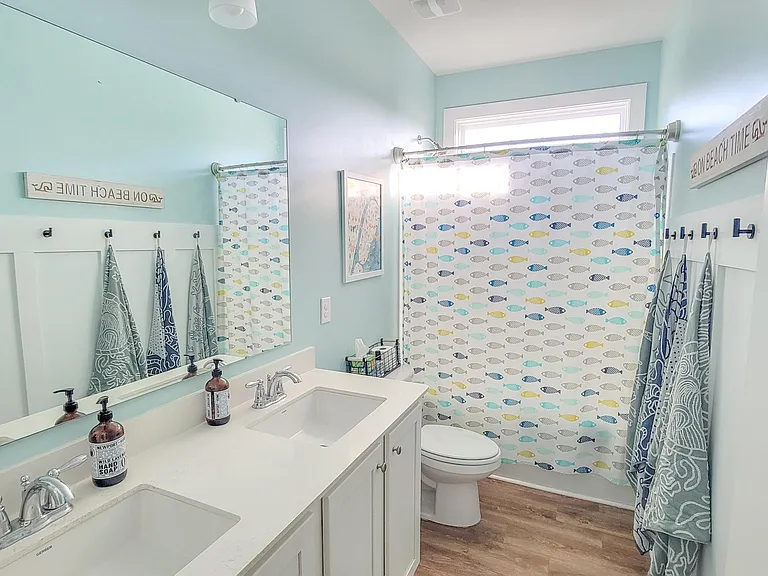 Hall bath with double sink and tub/shower