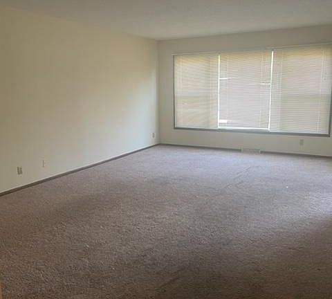 Large living room with new carpet to be installed.