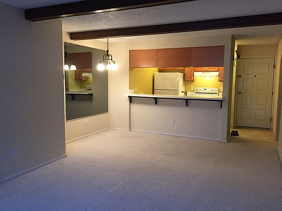 From living room towards dining room and kitchen and towards the entry door.