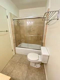 Travertine tile bathroom in hallway bathroom