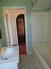 FULL BATHROOM LOOKING OUT INTO HALLWAY