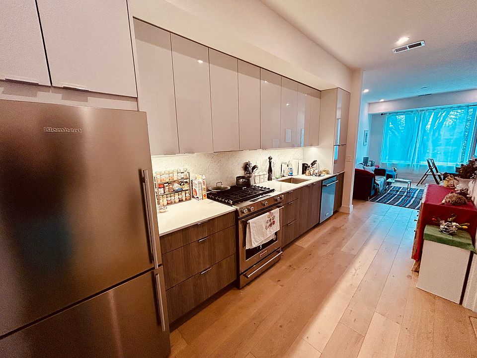 Kitchen has stainless steel appliances, including 5-burner range, dishwasher and microwave.