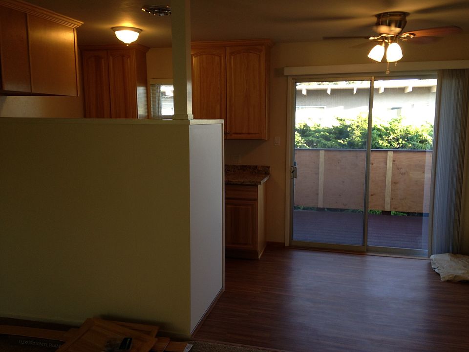 In living room looking at kitchen, eating area and balcony