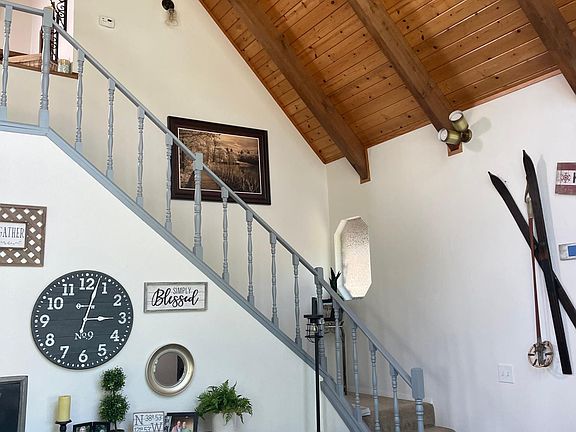 Stairs to the 2 bedrooms and bath upstairs with a loft.