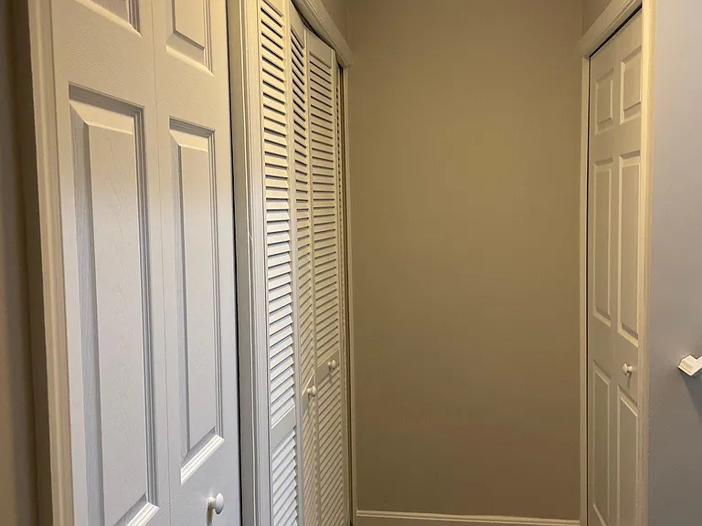 Hallway with closets and storage rooms