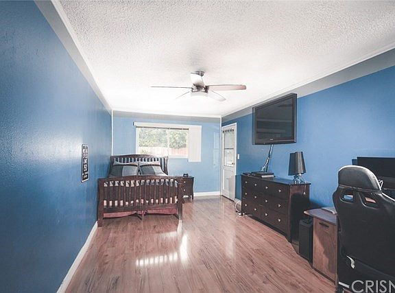 Extra large Bedroom features doorway leading to rear yard