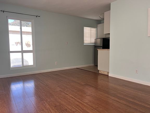 Spacious living area and kitchen in the corner.