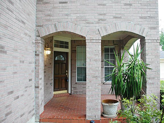 Unique corner entrance has it's own covered  patio.