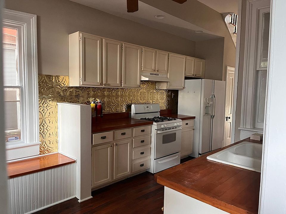 The kitchen has a refridgerator, stove and dishwasher.