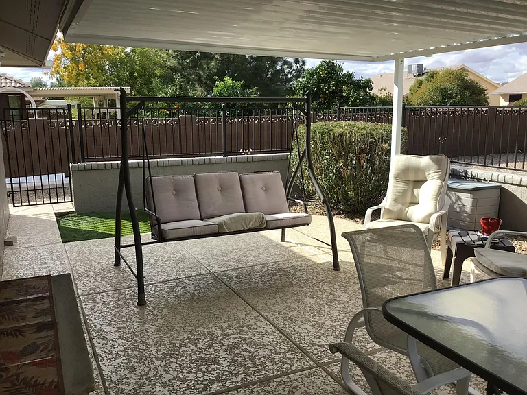 Covered rear patio with furnishings.
