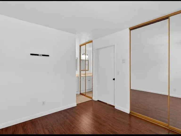 Bedroom and separate vanity closet looking in from bedroom window