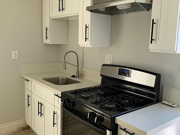 Kitchen features modern cabinetry and gas stove