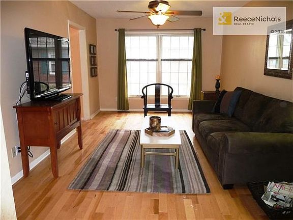 Living room features hardwood floor, wonderful light and warm neutral color.