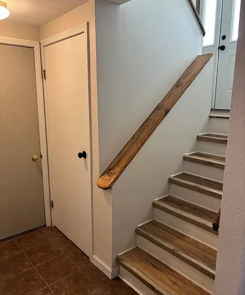Grand Double Staircase Entry with Split-Level Design and Foyer Storage