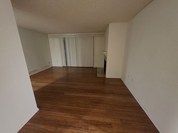 From hallway, front door on the left, looking out to the living room. Dining room behind