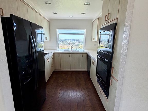 Fully-equipped galley kitchen with views.