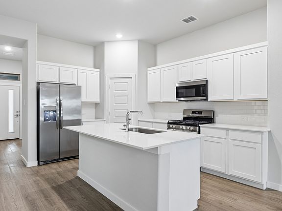 Kitchen in the Cedar home plan by Trophy Signature Homes - REPRESENTATIVE PHOTO