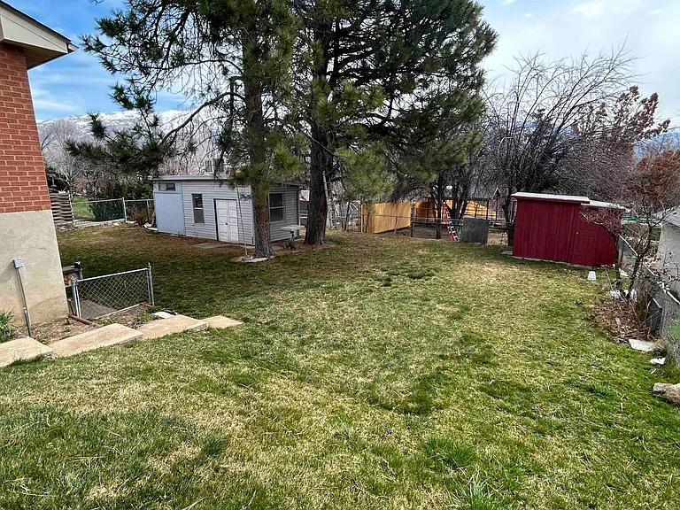 side and back yard with large work shed and small storage shed