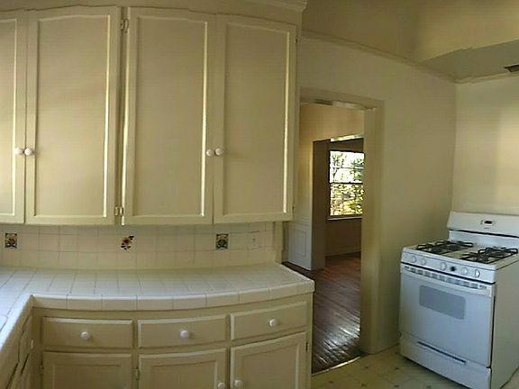 Kitchen with lots of cabinets, refrigerator and stove