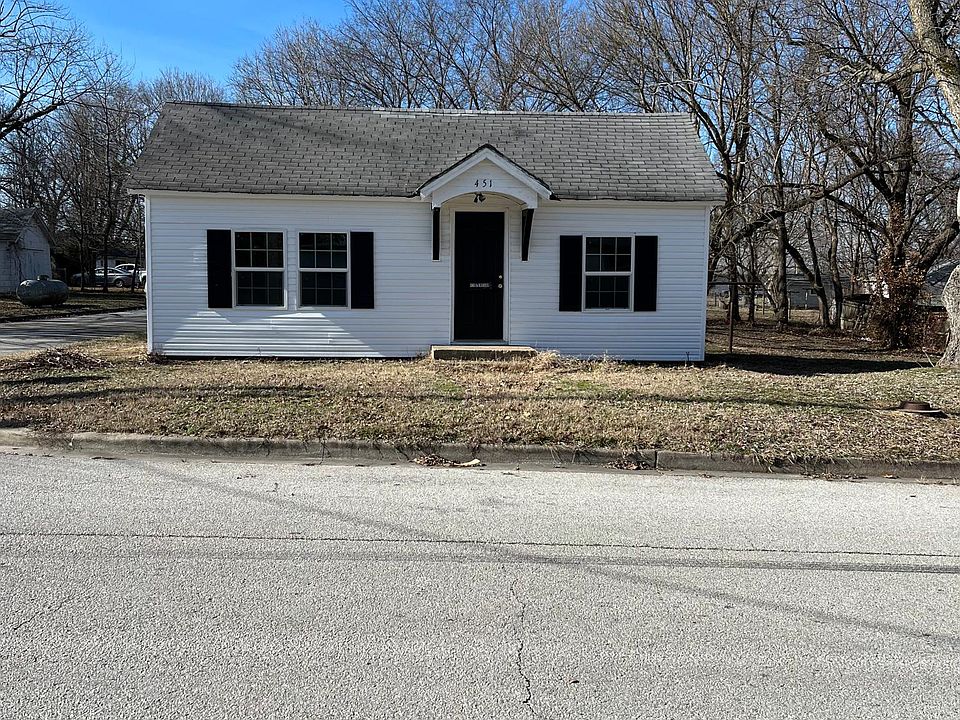 New shutters, siding, and paint on door.
