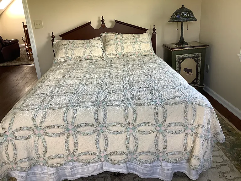 Queen size bed, night stand, lamp.
