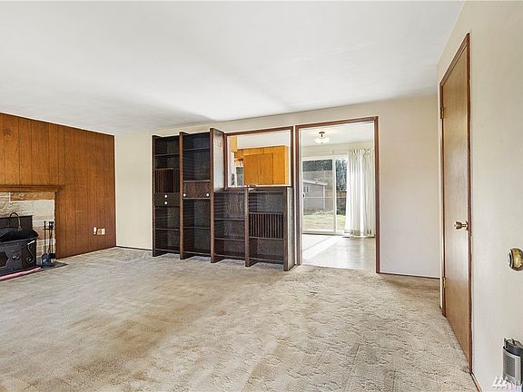 Front door entry into living room. Beautiful hardwood floors under carpet!  