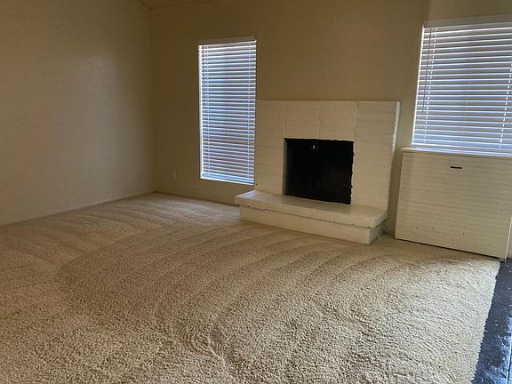 living room with fireplace back patio