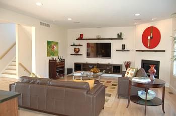 Living room has a beautiful view of the woods.  It is very private and comfortable surrounded by exquisite  custom built-ins accents.