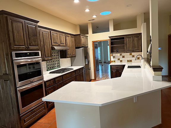 Chef's kitchen includes SS appliances, double oven, gas stovetop, quartz countertop, lots of storage. Kitchen opens into breakfast area and family room!