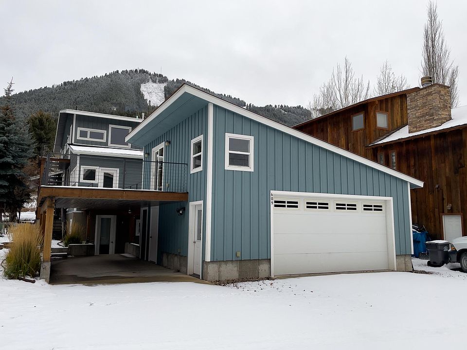 Back exterior with parking in Winter.
