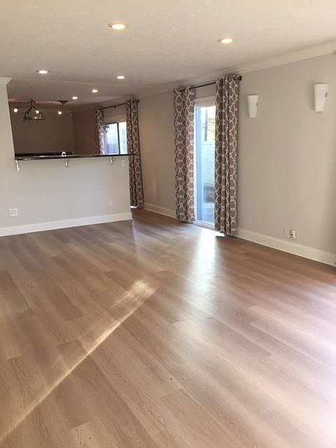 Open concept living and dining space overlooking garden area.