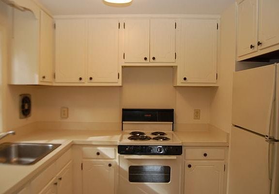 galley kitchen, stove and refrigerator