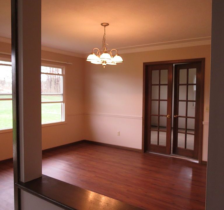 Room has china doors, chair rail, ceiling racetrack & crown