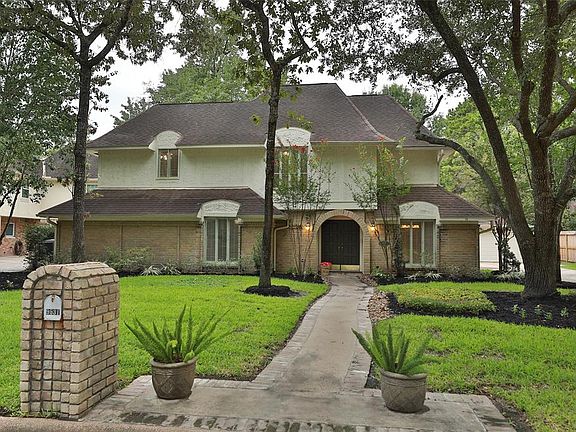 CHARMING STREET WITH MATURE TREES - This charming English style home features a brick and stucco exterior complimented with a full walkway to the arched brick entry. Recent landscaping makes for a lovely setting. The driveway is to the right with a d