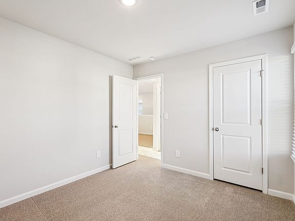 Secondary bedroom in the Lennon floorplan at a Meritage Homes community in Garner, NC.