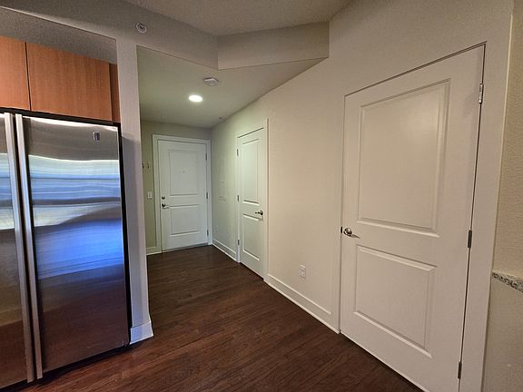 Entryway facing the front door and spare bedroom.